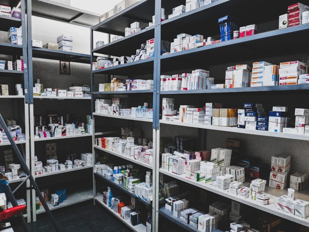 A person comparing medication boxes and bottles while reading drug labels at home.