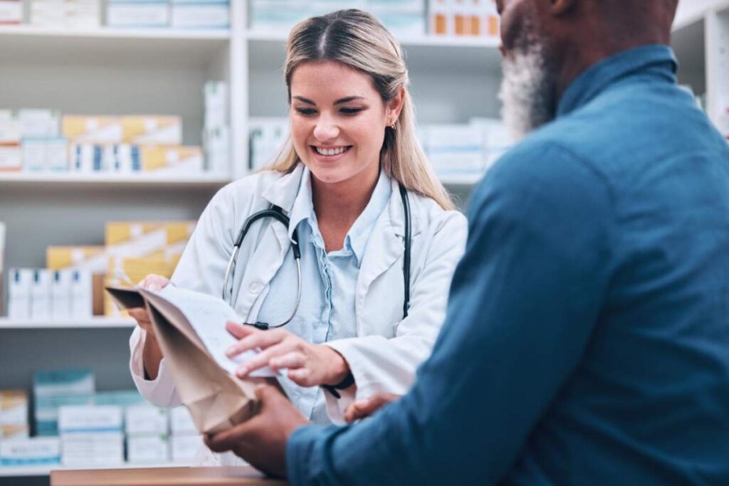 Person reading expiration date on prescription medication bottle at home counter