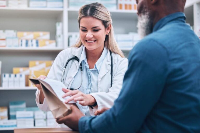 Person reading expiration date on prescription medication bottle at home counter